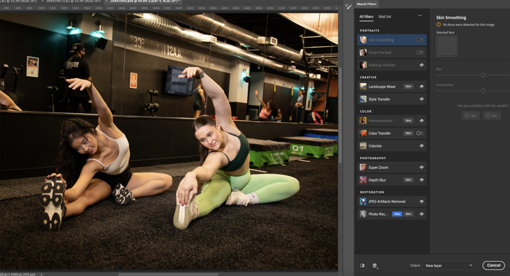 two women stretch on gym turf
