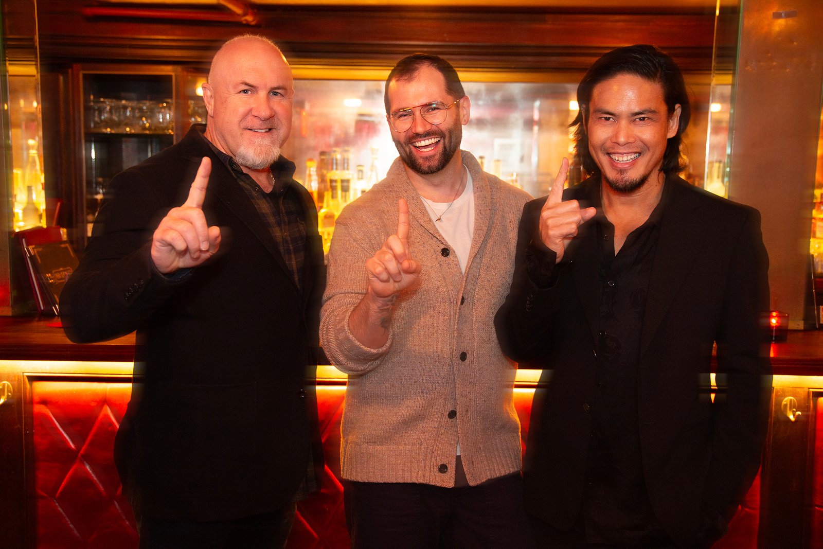 three men hold up number one gesture to mark the occassion celebrating the best employees