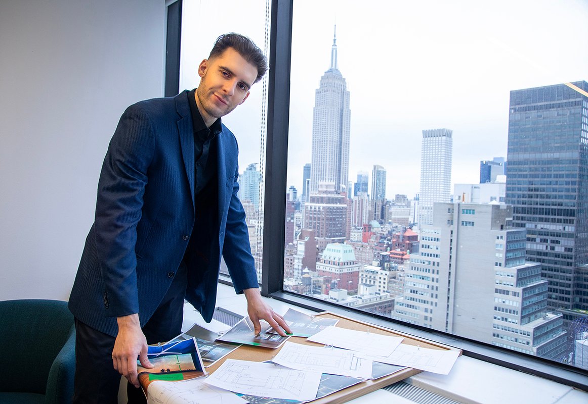 man looks away from bulletin board of ideas in front of him